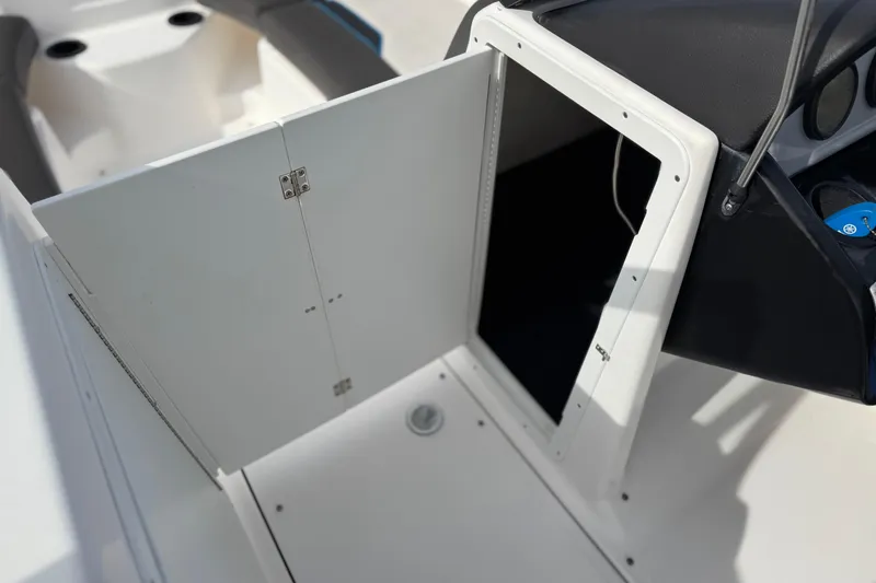 Slide: The Image of 2020 Yamaha Boats AR210 interior storage compartment with open door. - 31