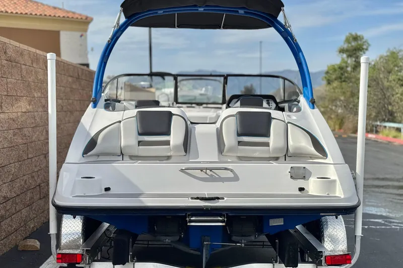 Slide: The Image of 2020 Yamaha Boats AR210 on trailer, rear view, parked outdoors. - 4
