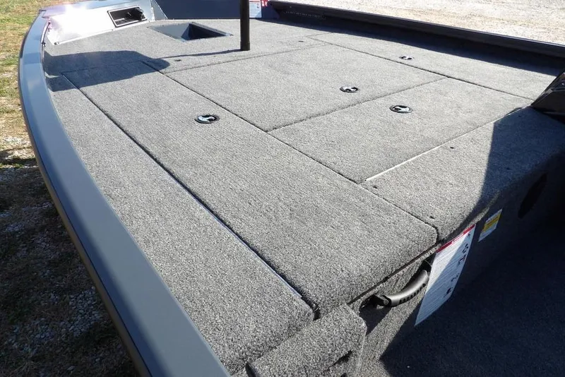 Slide: The Image of 2026 Crestliner XFC 189 boat deck with gray carpet and storage compartments. - 12