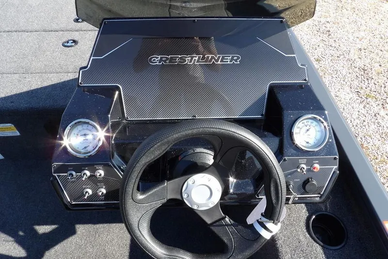 Slide: The Image of 2026 Crestliner XFC 189 boat dashboard with steering wheel and gauges. - 16