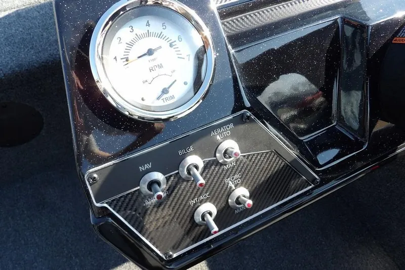 Slide: The Image of Dashboard of 2026 Crestliner XFC 189 boat with RPM gauge and control switches. - 17