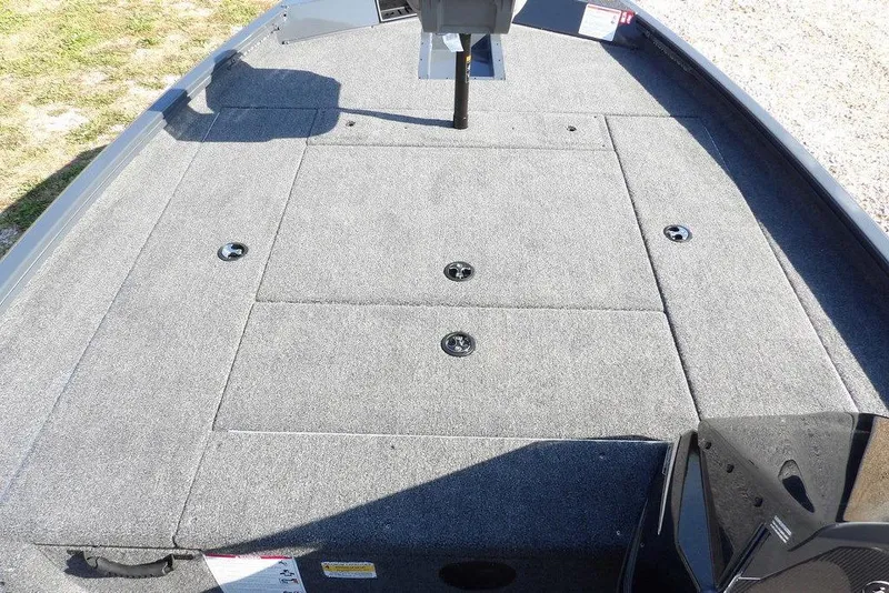 Slide: The Image of 2026 Crestliner XFC 189 boat deck with gray carpet and storage compartments. - 25