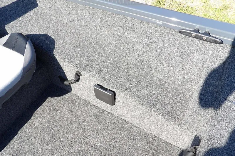 Slide: The Image of 2026 Crestliner XFC 189 boat interior with gray carpet and seating detail. - 26