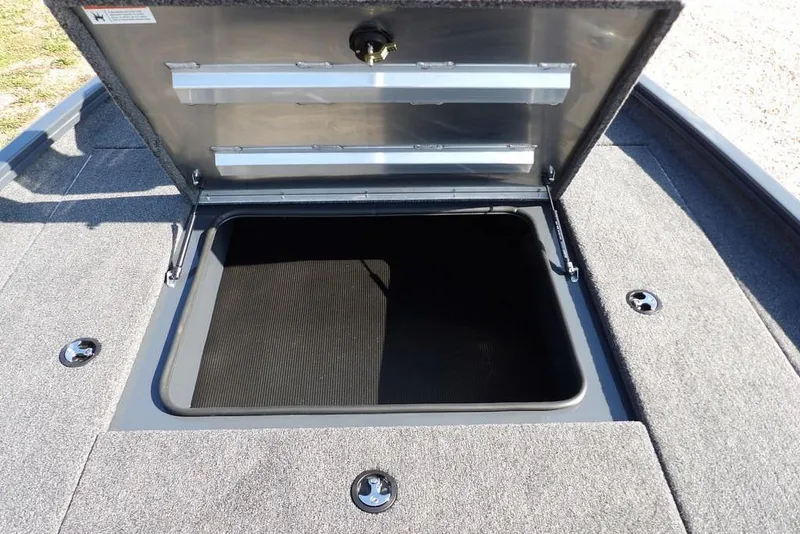 Slide: The Image of Open storage compartment on 2026 Crestliner XFC 189 boat, featuring carpeted interior. - 31