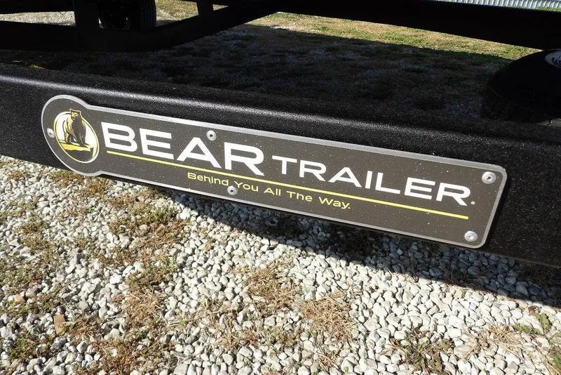 Slide: The Image of Bear Trailer logo on a Crestliner XFC 189, 2026 model, parked on gravel. - 34