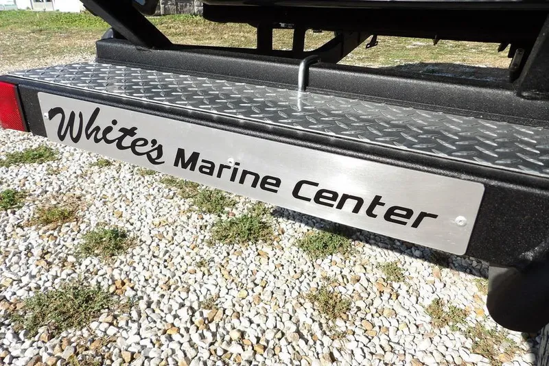 Slide: The Image of White's Marine Center sign on Crestliner XFC 189, 2026 model, on gravel surface. - 39