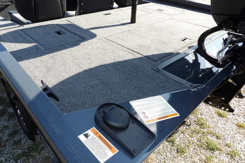 Slide: The Image of 2026 Crestliner XFC 189 boat deck with carpeted surface and warning label. - 5