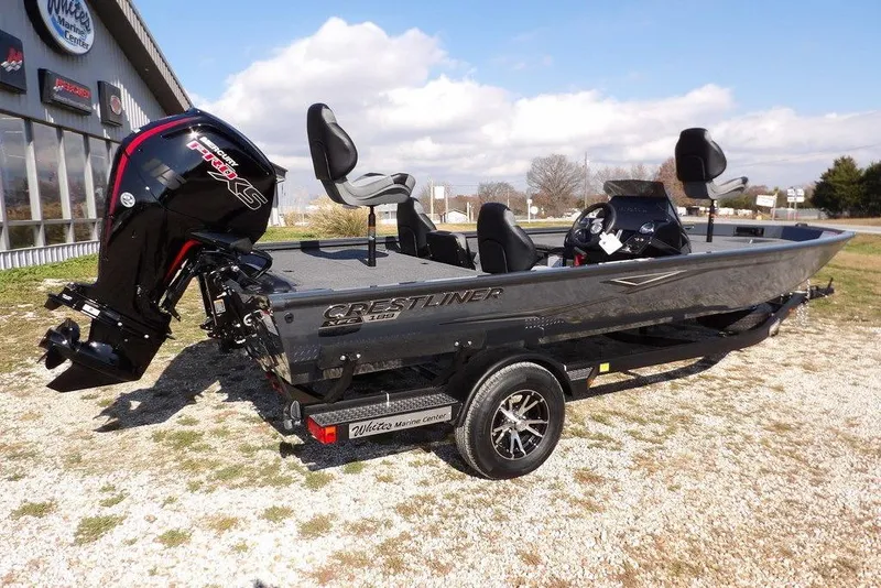 Slide: The Image of 2026 Crestliner XFC 189 fishing boat with powerful outboard motor, parked outdoors. - 6