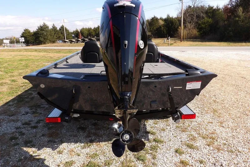 Slide: The Image of 2026 Crestliner XFC 189 boat with powerful outboard motor, parked on gravel. - 8