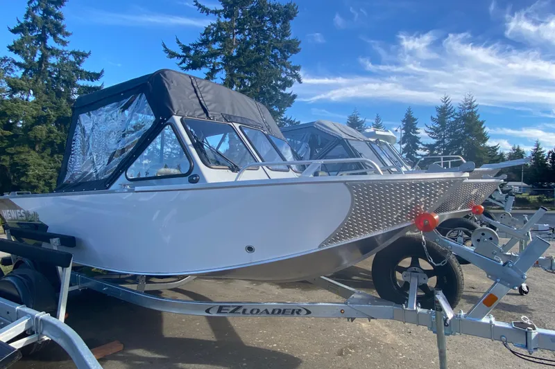 Slide: The Image of 2026 Hewescraft 180 Sportsman boat on trailer outdoors. - 2