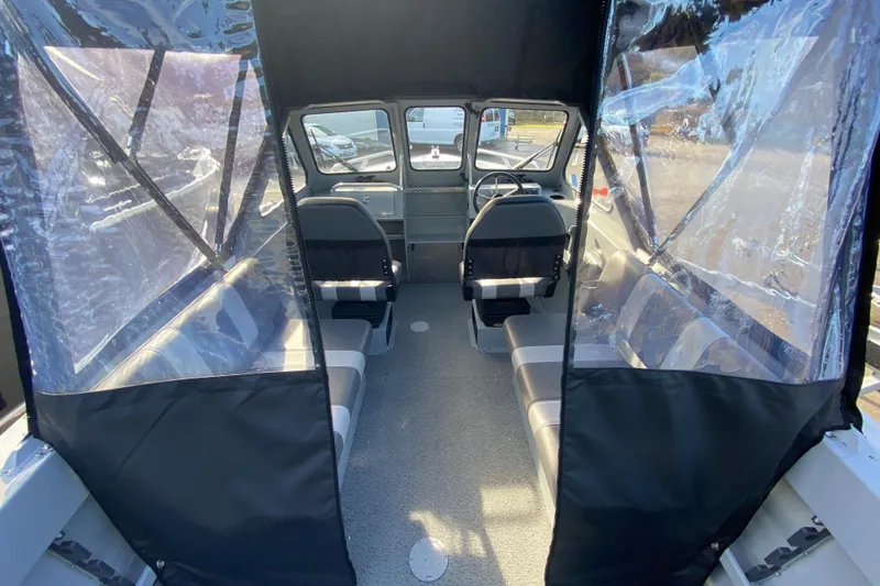 Slide: The Image of Interior of 2026 Hewescraft 180 Sportsman with seating and helm. - 4