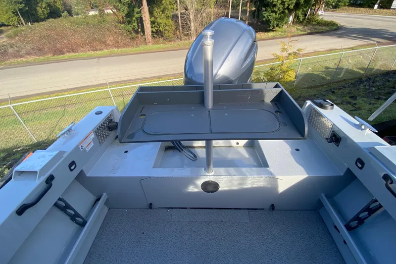 Slide: The Image of Hewescraft 180 Sportsman 2026 boat rear with motor and storage. - 6