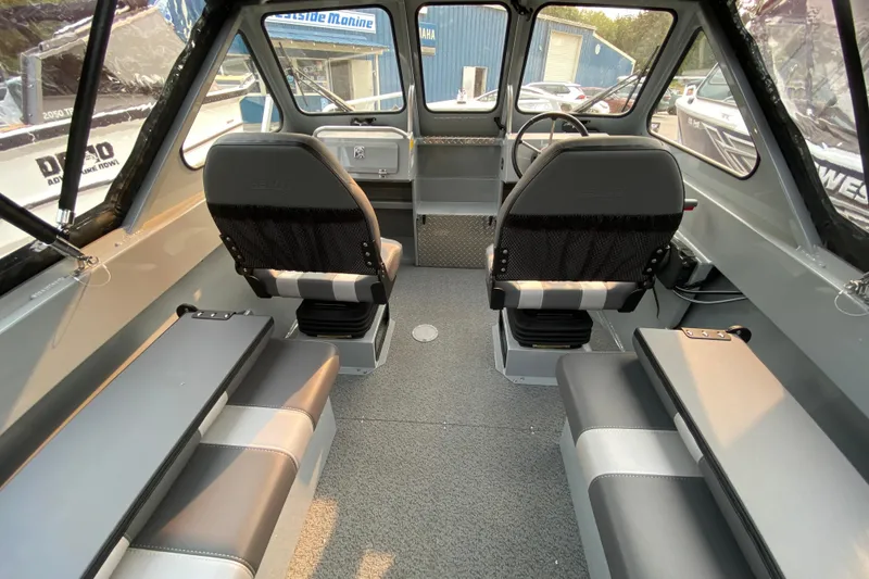 Slide: The Image of 2026 Hewescraft 180 Sportsman boat interior with seating and steering wheel. - 7