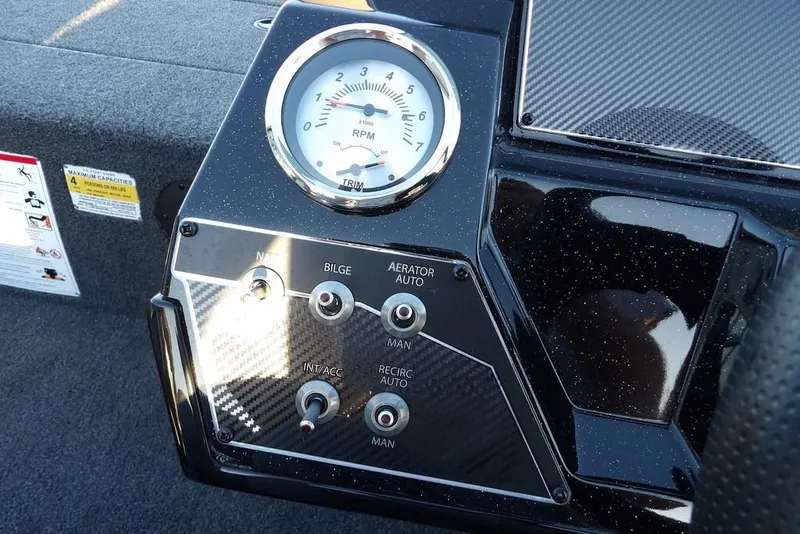 Slide: The Image of Dashboard controls of 2026 Crestliner XFC 189 boat with RPM gauge and switches. - 18