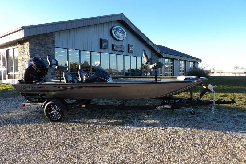 Slide: The Image of 2026 Crestliner XFC 189 boat on trailer outside a marine center. - 2