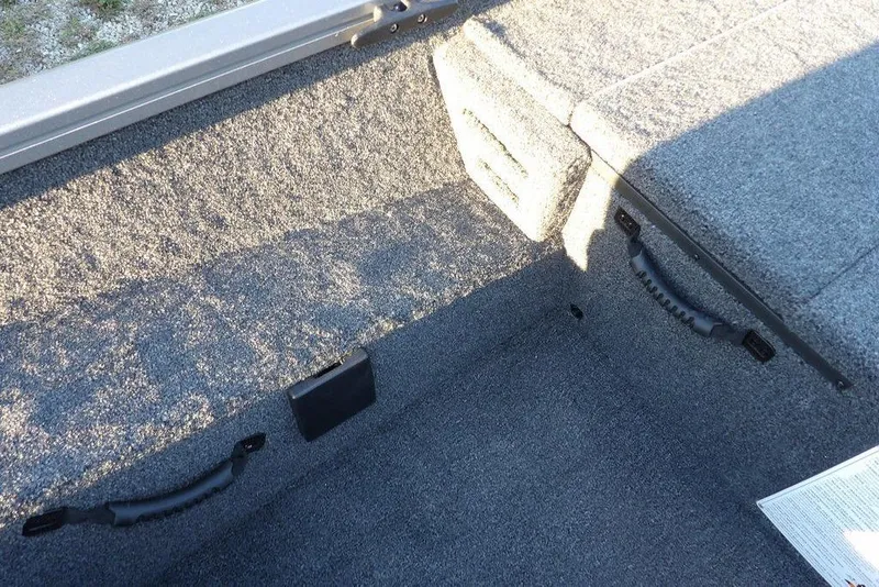 Slide: The Image of Interior of 2026 Crestliner XFC 189 boat with carpeted flooring and storage compartments. - 23