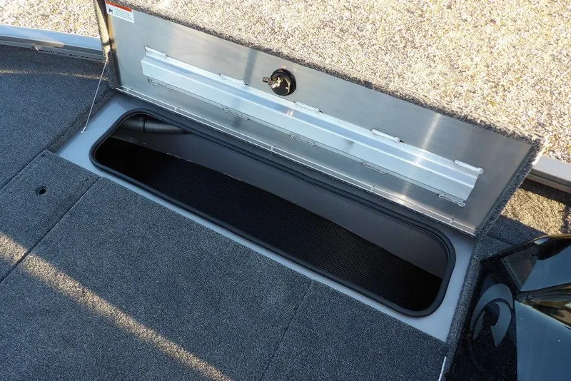 Slide: The Image of Open storage compartment on 2026 Crestliner XFC 189 boat, featuring carpeted interior. - 29