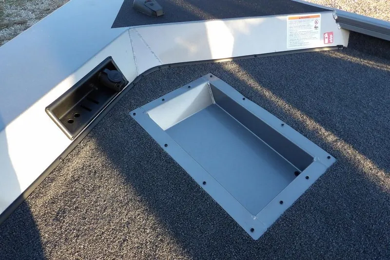 Slide: The Image of 2026 Crestliner XFC 189 boat deck with storage compartment and carpeted surface. - 30