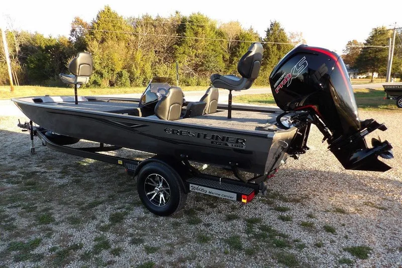 Slide: The Image of 2026 Crestliner XFC 189 fishing boat with powerful outboard motor on trailer. - 5
