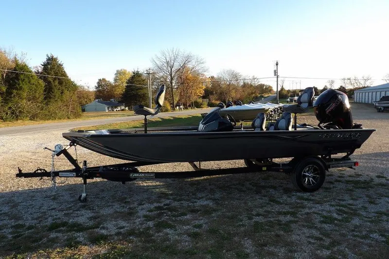 Slide: The Image of 2026 Crestliner XFC 189 fishing boat on trailer, parked outdoors in a rural setting. - 6