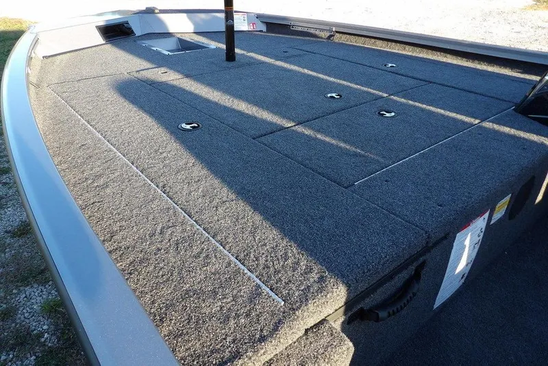 Slide: The Image of 2026 Crestliner XFC 189 boat deck with carpeted surface and storage compartments. - 8