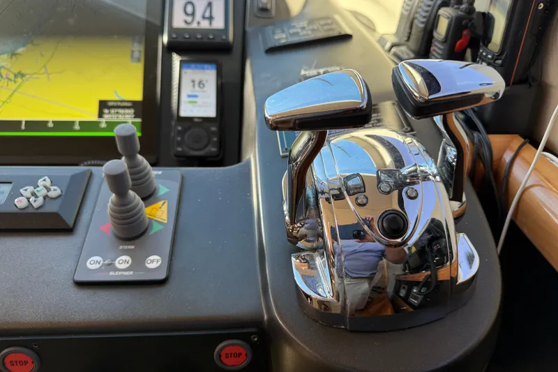 Slide: The Image of Control panel of a 2005 Sunseeker 75 Yacht with navigation and throttle controls. - 11