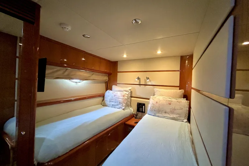 Slide: The Image of Luxurious twin cabin interior of 2005 Sunseeker 75 Yacht, featuring elegant wood paneling. - 29