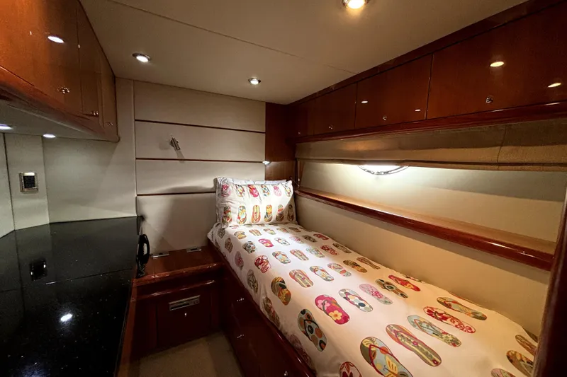 Slide: The Image of Luxurious cabin interior of 2005 Sunseeker 75 Yacht with single bed and wooden cabinetry. - 33