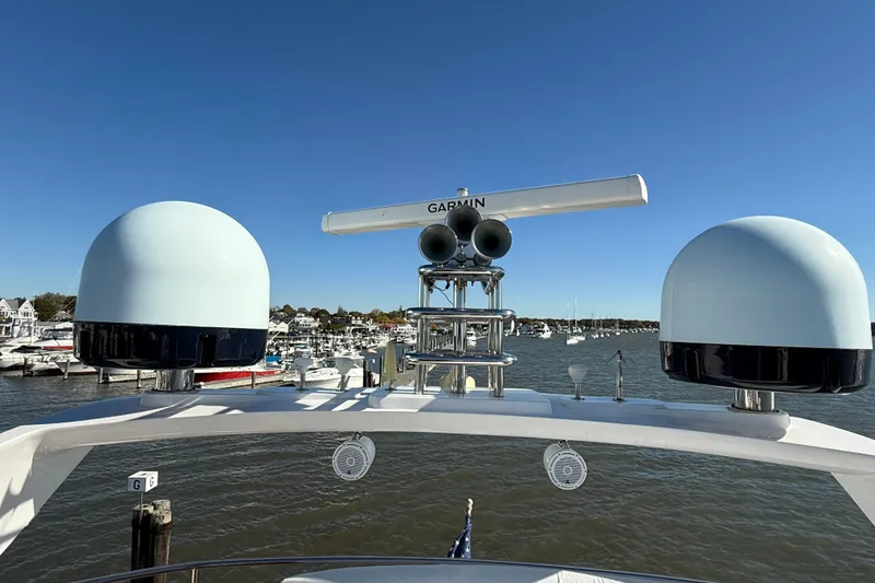 Slide: The Image of 2005 Sunseeker 75 Yacht radar equipment with marina view under clear blue sky. - 40