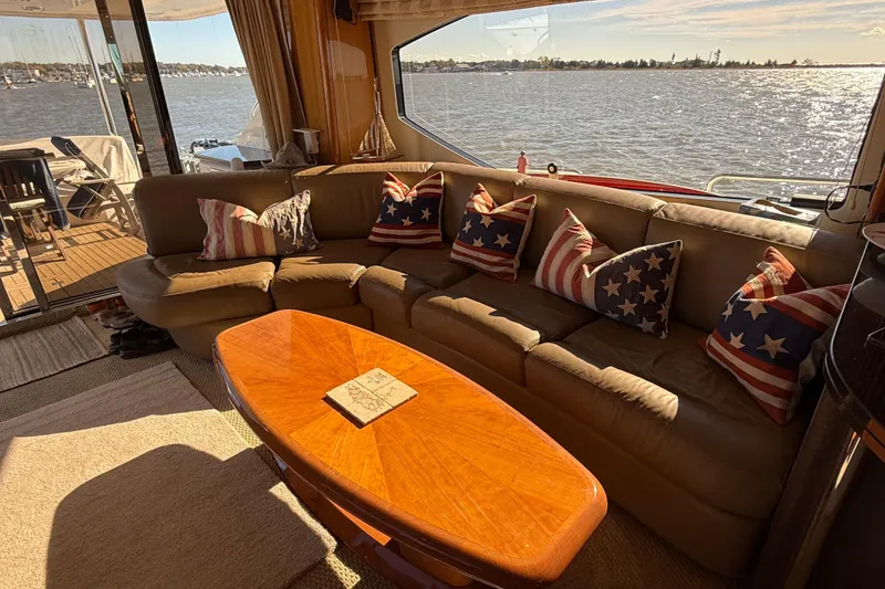 Slide: The Image of Luxurious 2005 Sunseeker 75 Yacht interior with star-patterned cushions and scenic water view. - 6