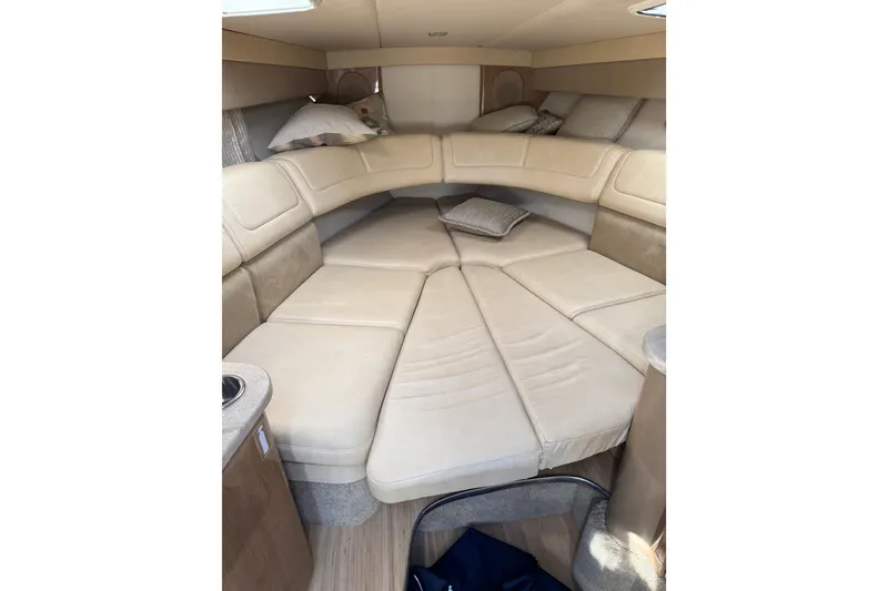 Slide: The Image of 2014 Formula 310 Sun Sport cabin interior with beige seating and cushions. - 10