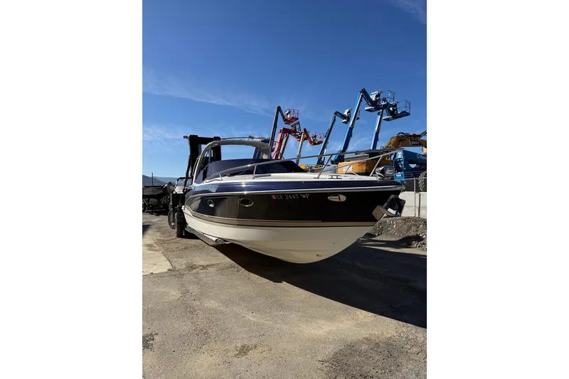 Slide: The Image of 2014 Formula 310 Sun Sport boat on dry land with clear blue sky background. - 2