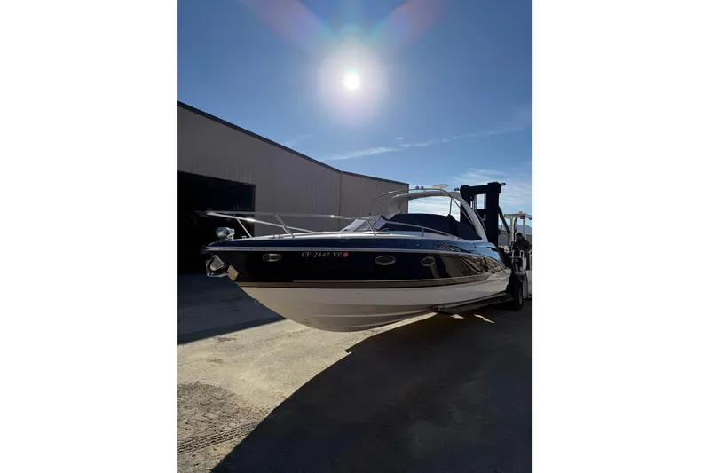 Slide: The Image of 2014 Formula 310 Sun Sport boat in sunlight, parked near a building. - 3