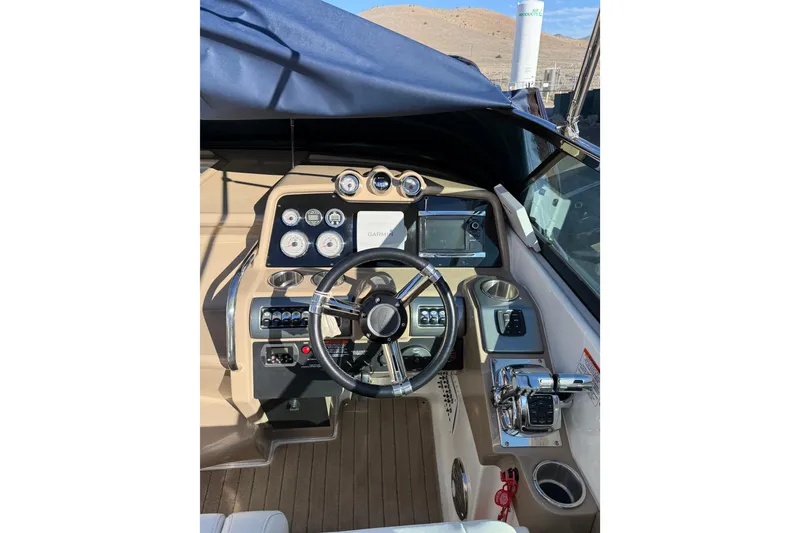 Slide: The Image of 2014 Formula 310 Sun Sport boat cockpit with steering wheel and control panel. - 4