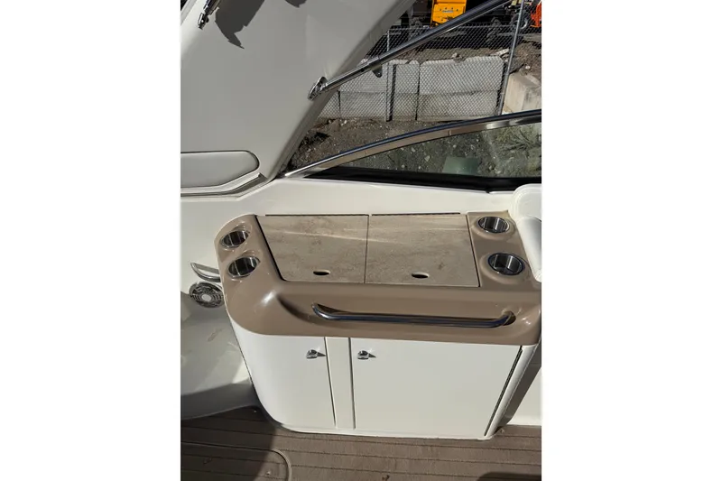 Slide: The Image of 2014 Formula 310 Sun Sport boat interior with cup holders and storage. - 7