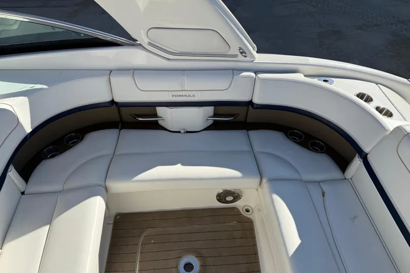 Slide: The Image of 2014 Formula 310 Sun Sport boat interior with white seating and cup holders. - 9
