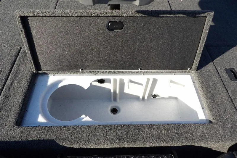 Slide: The Image of 2026 Crestliner XFC 189 boat storage compartment with open lid, showcasing interior space. - 12