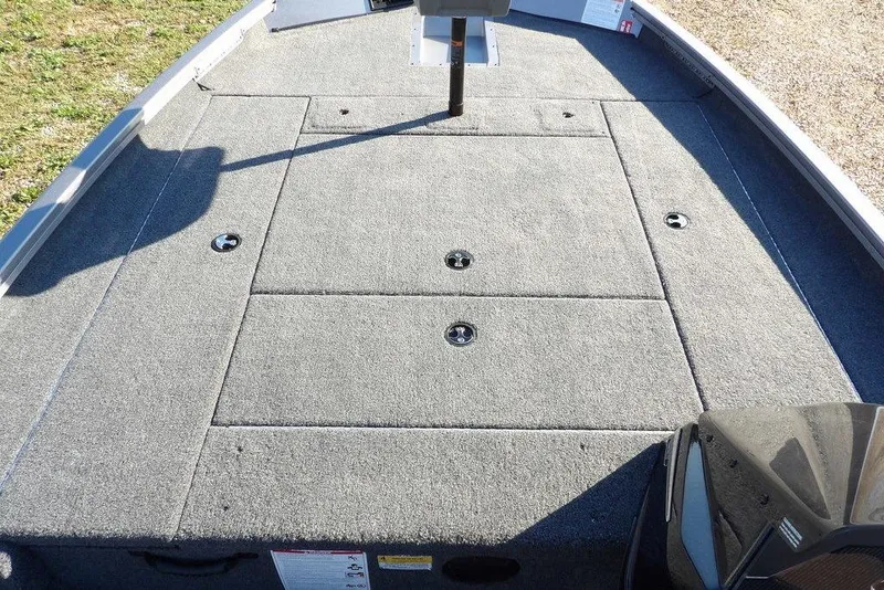 Slide: The Image of 2026 Crestliner XFC 189 boat deck with carpeted surface and storage compartments. - 26