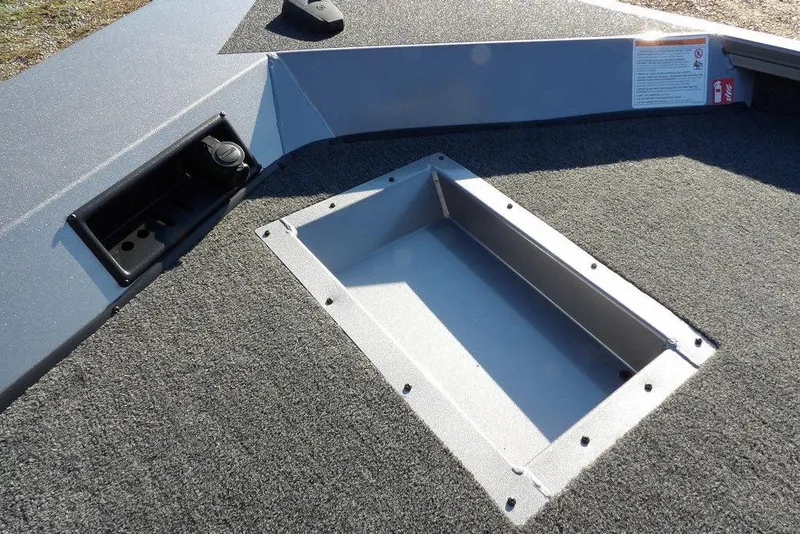 Slide: The Image of 2026 Crestliner XFC 189 boat deck with storage compartment and carpeted surface. - 28