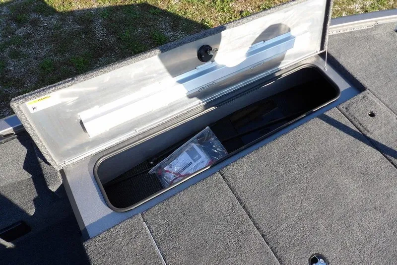 Slide: The Image of Open storage compartment in 2026 Crestliner XFC 189 boat, showing interior space. - 29