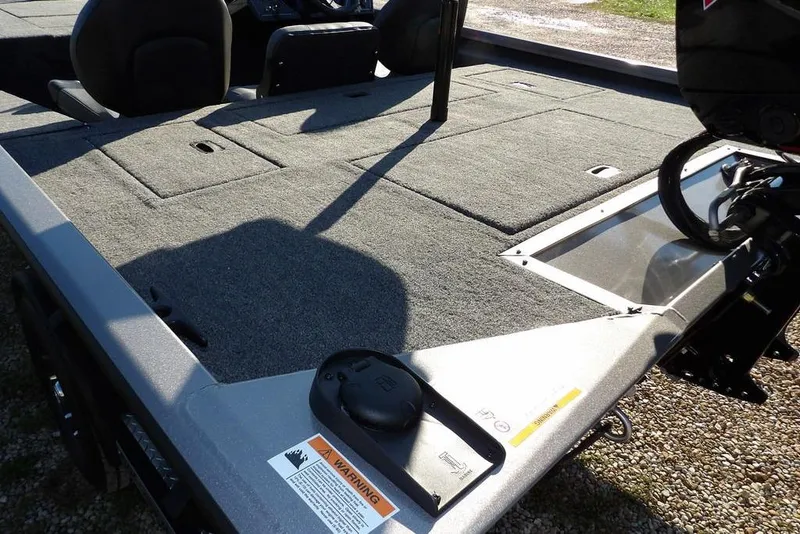 Slide: The Image of 2026 Crestliner XFC 189 boat deck with carpeted surface and storage compartments. - 4