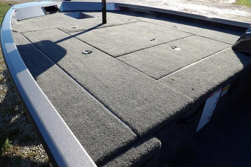 Slide: The Image of 2026 Crestliner XFC 189 boat deck with carpeted surface and storage compartments. - 9