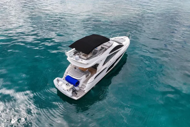 Slide: The Image of 2016 Sunseeker Manhattan 55 yacht on clear blue water, aerial view. - 12