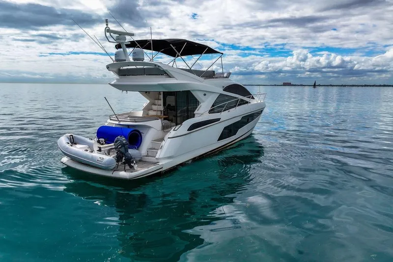 Slide: The Image of 2016 Sunseeker Manhattan 55 yacht on calm ocean waters under cloudy sky. - 13