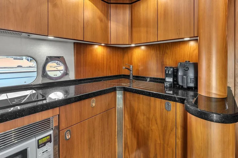 Slide: The Image of Luxurious kitchen interior of 2016 Sunseeker Manhattan 55 yacht with wood cabinetry and modern appliances. - 39