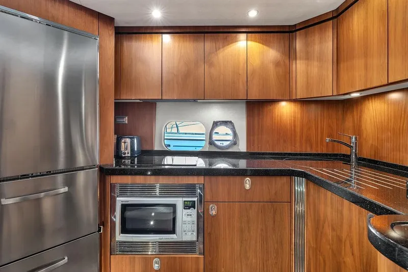 Slide: The Image of Luxurious 2016 Sunseeker Manhattan 55 yacht kitchen with modern appliances and sleek wood cabinetry. - 40