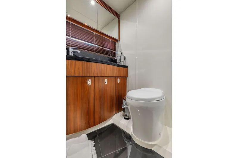 Slide: The Image of Luxury bathroom in 2016 Sunseeker Manhattan 55 yacht with modern fixtures and wood cabinetry. - 49