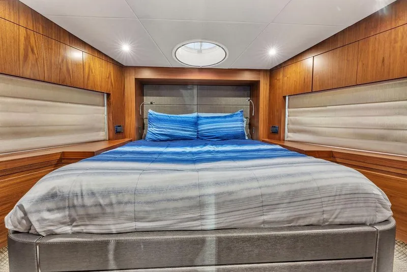 Slide: The Image of Luxurious bedroom interior of 2016 Sunseeker Manhattan 55 yacht with wood paneling and blue bedding. - 52