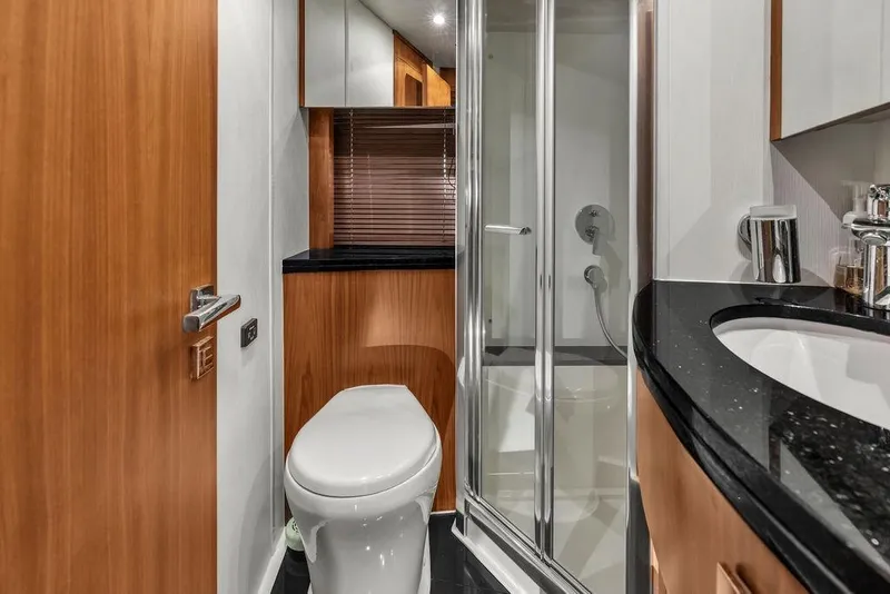 Slide: The Image of Luxurious bathroom in 2016 Sunseeker Manhattan 55 yacht with modern fixtures and wood accents. - 53