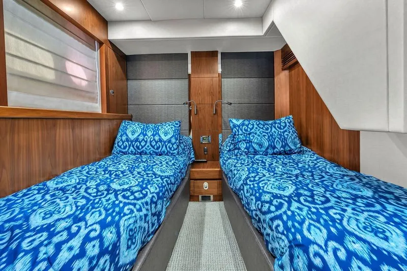 Slide: The Image of Luxurious twin cabin in 2016 Sunseeker Manhattan 55 yacht with blue patterned bedding. - 57